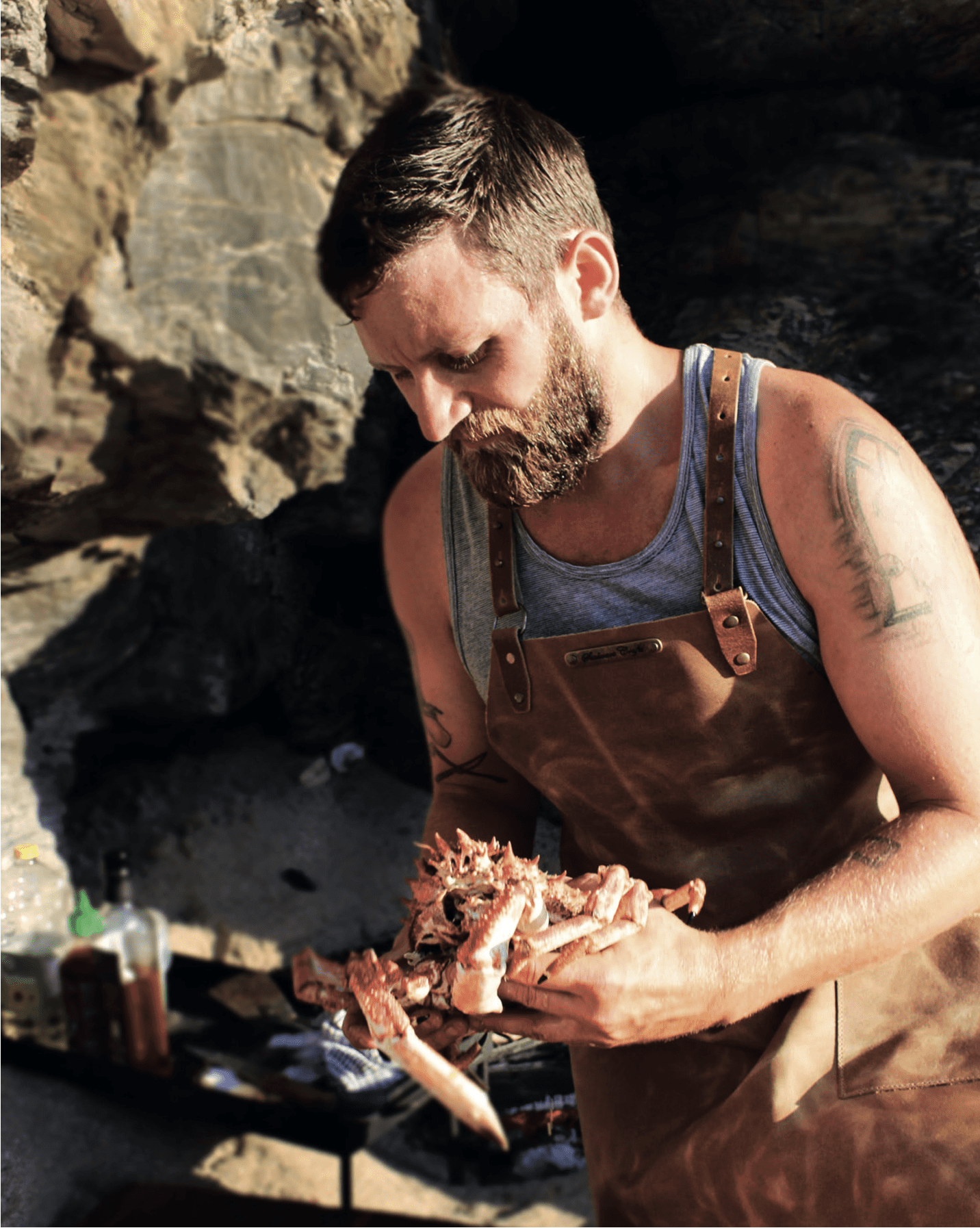 Man in Cross Strap Apron Holding Crab